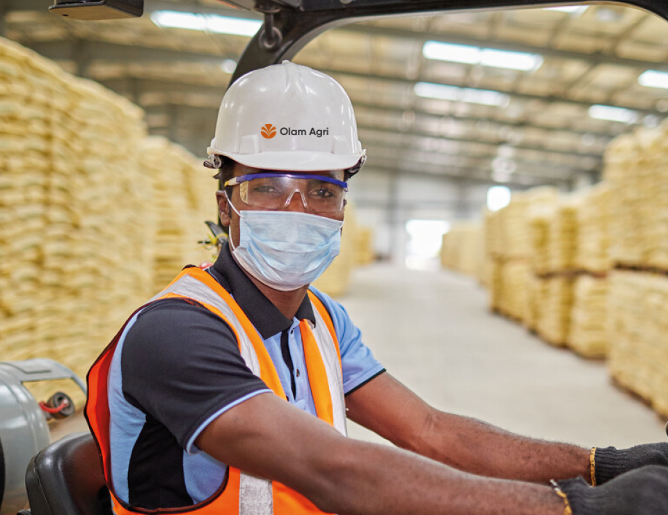Olam Agri employee on a forklift