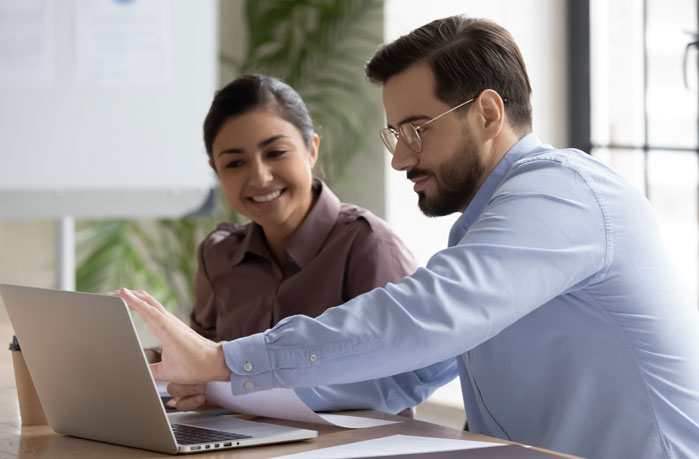 Two people sat at a desk